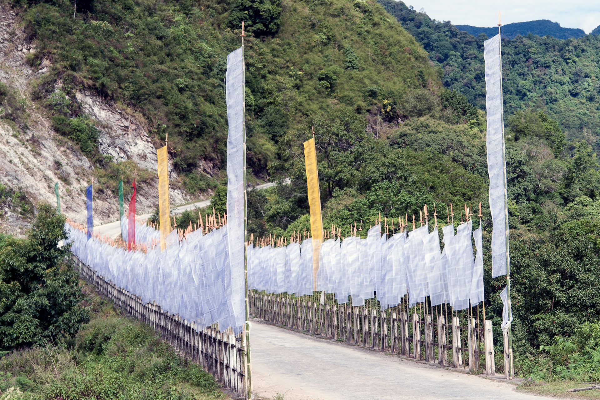 Buddhist prayer flags on a road bridge near Trashigang, Bhutan