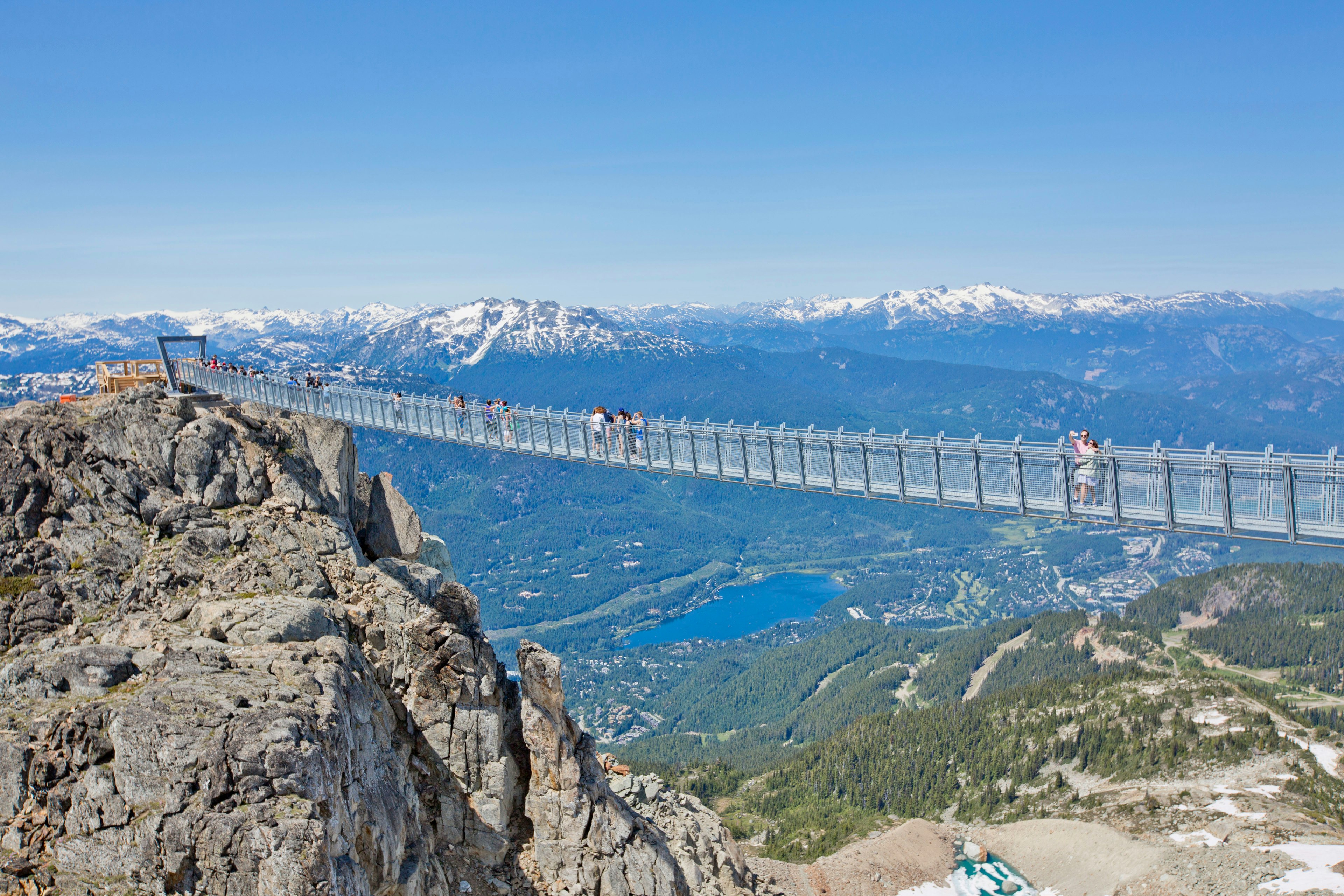 People walk along the Cloudraker Skybridge, Whistler Mountain, British Columbia, Canada