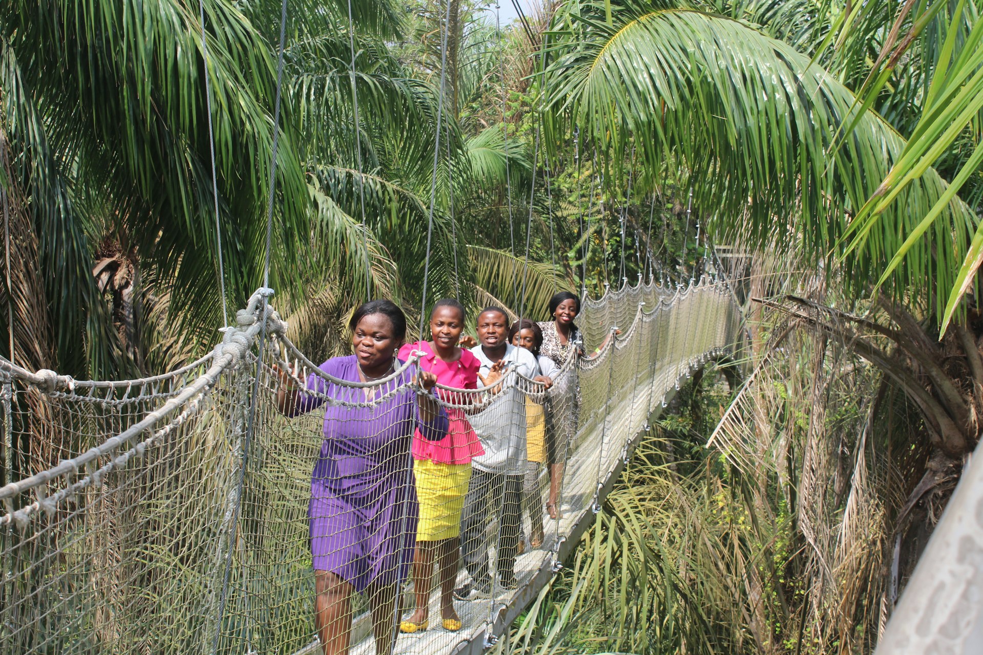 Women walk on a rope bridge in the canopy reserve at Lekki Conservation Foundation, Lagos, Nigeria