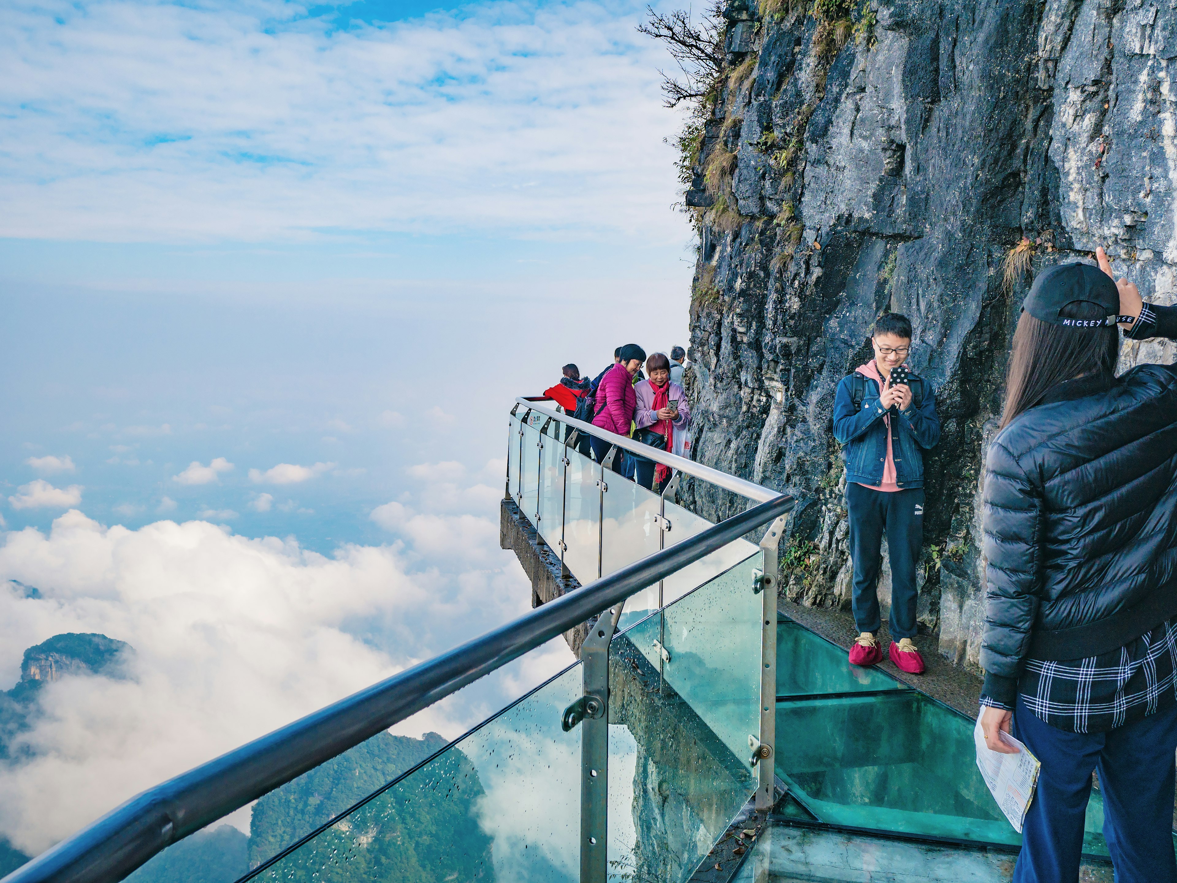 Visitors on the glass cliff walk at Tianmen Mtn, Zhangjiajie, China