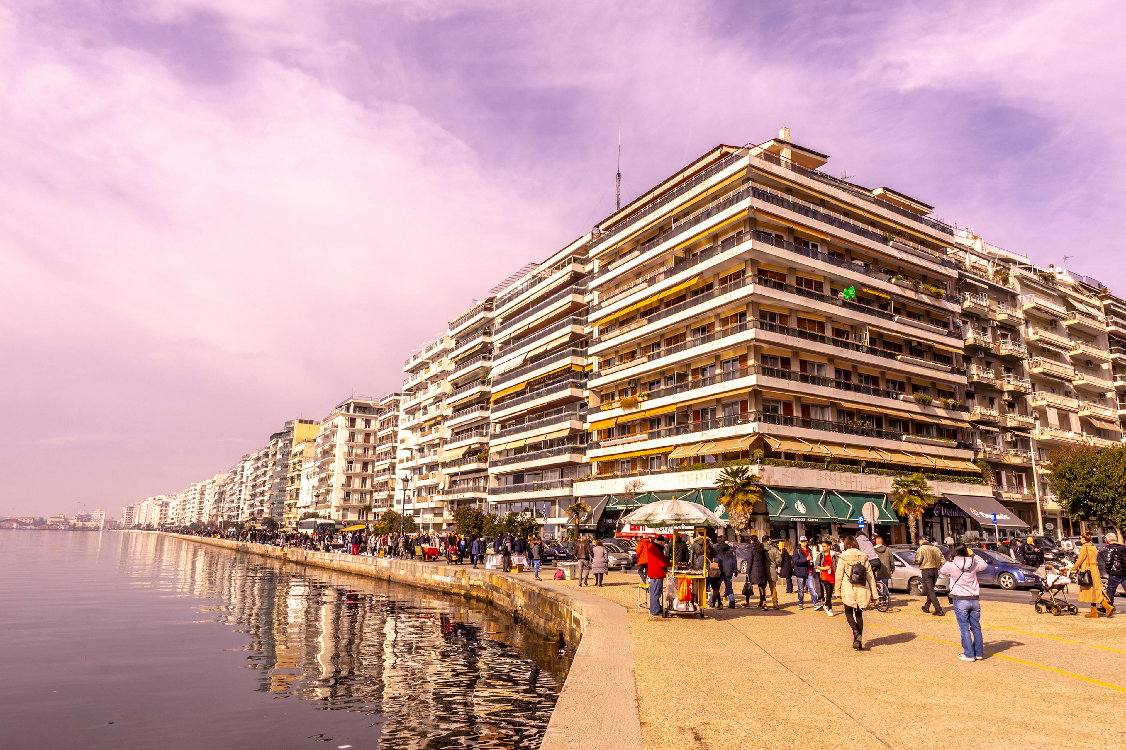 People walk by buildings on the New Waterfront promenade, Thessaloniki, Macedonia, Greece