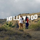 Hollywood, California/ USA  11-21-19 Two young people hiking in Hollywood California's Griffith Park stop to  admire a famous sign in the Hollywood Hills; Shutterstock ID 1575362842; full: 65050; gl: Lonely Planet Online Editorial; netsuite: Best hikes in LA; your: Brian Healy
1575362842
adventure, america, american, blue, california, destinations, famous, griffith, high, hike, hiking, hill, hills, hillside, hollywood, iconic, la, landmark, landscape, los angeles, monica, mount, mountain, nature, outdoor, park, people, rock, santa, santa monica, sight, sightseeing, sky, summer, tourism, tower, trail, travel, trekking, usa, vacation, view, western, white