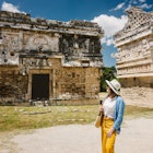 Girl tourist walks through the ancient Mayan complex Chichen Itza.A popular tourist destination in the Yucatan - Chichen Itza complex ; Shutterstock ID 2077363255; purchase_order: 65050; job: Cancun day trips; client: Online ed; other: ClaireN
2077363255