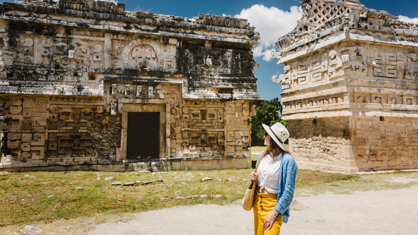 Girl tourist walks through the ancient Mayan complex Chichen Itza.A popular tourist destination in the Yucatan - Chichen Itza complex ; Shutterstock ID 2077363255; purchase_order: 65050; job: Cancun day trips; client: Online ed; other: ClaireN
2077363255