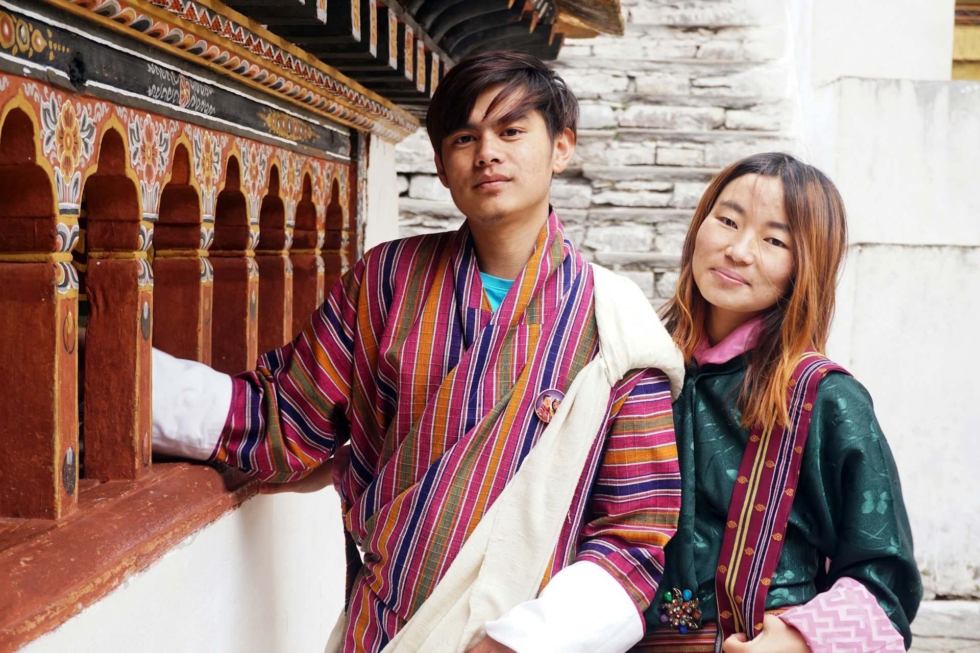 A young Bhutanese couple wearing traditional clothing 'Gho' and 'Kira'