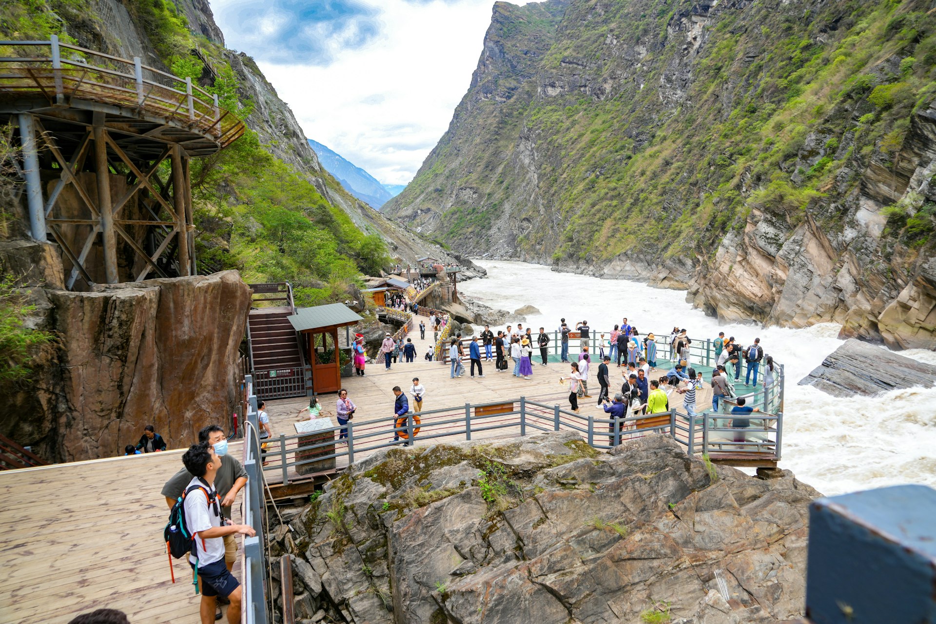 Tourists on a viewing platform at Tiger Leaping Gorge, Yunnan
