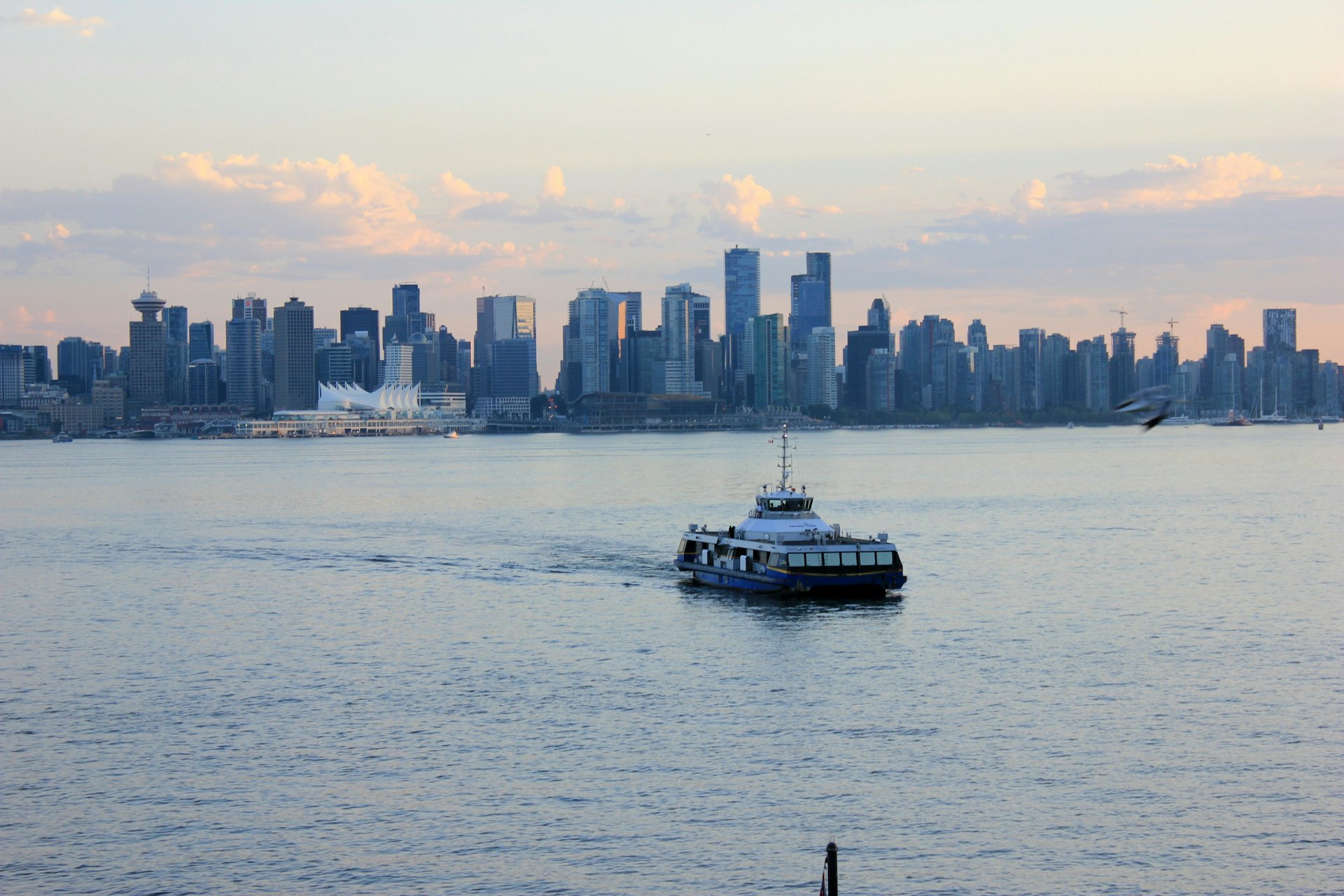 A Seabus ferry on the water against the skyline of downtown Vancouver, British Columbia, Canada