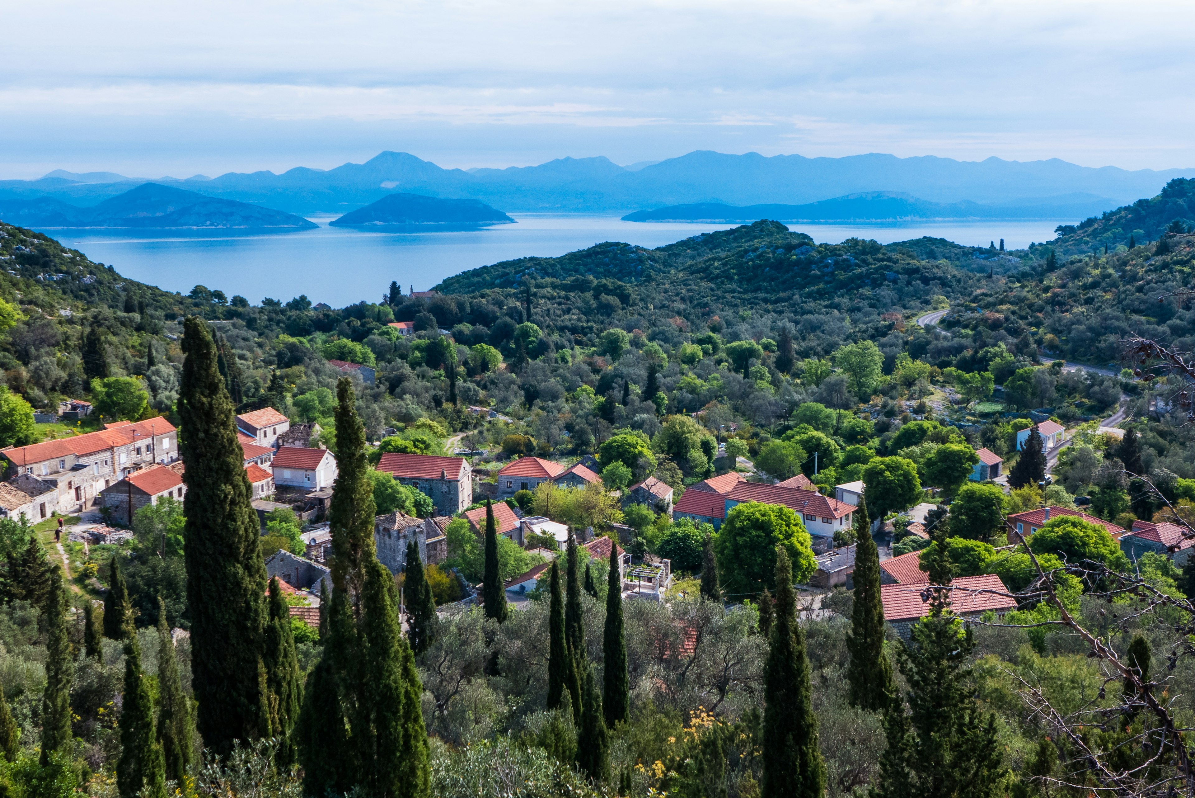 A view of a small village, forested mountains and the Adriatic Sea in the distance on Mljet, Croatia