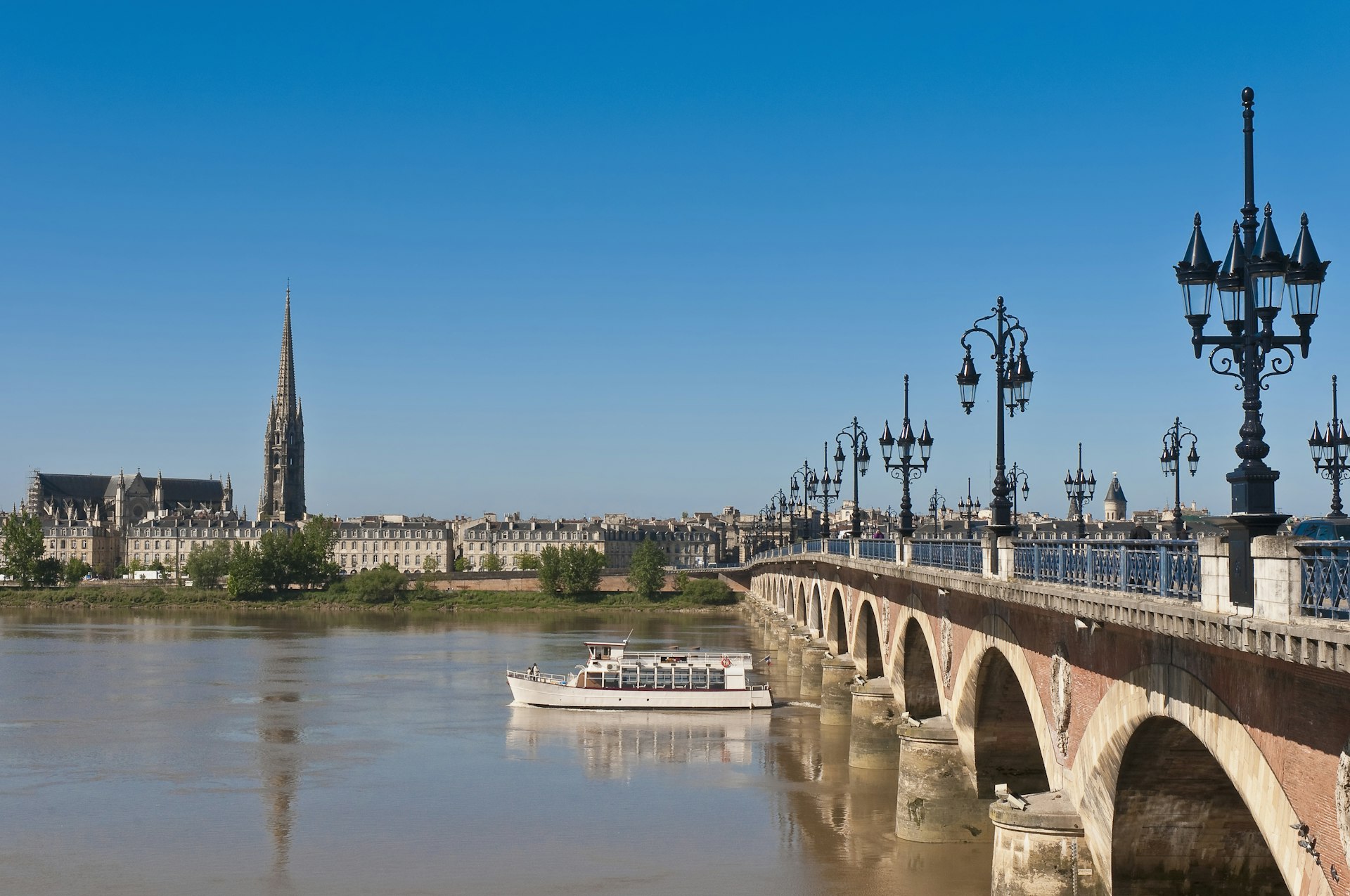A boat passes under St-Pierre bridge on the Garonne River, Bordeaux, France