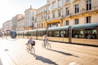 BORDEAUX, FRANCE - May 24, 2017: Street view with people ride a bicycles and modern trams in Bordeaux city during the morning in France
674653339