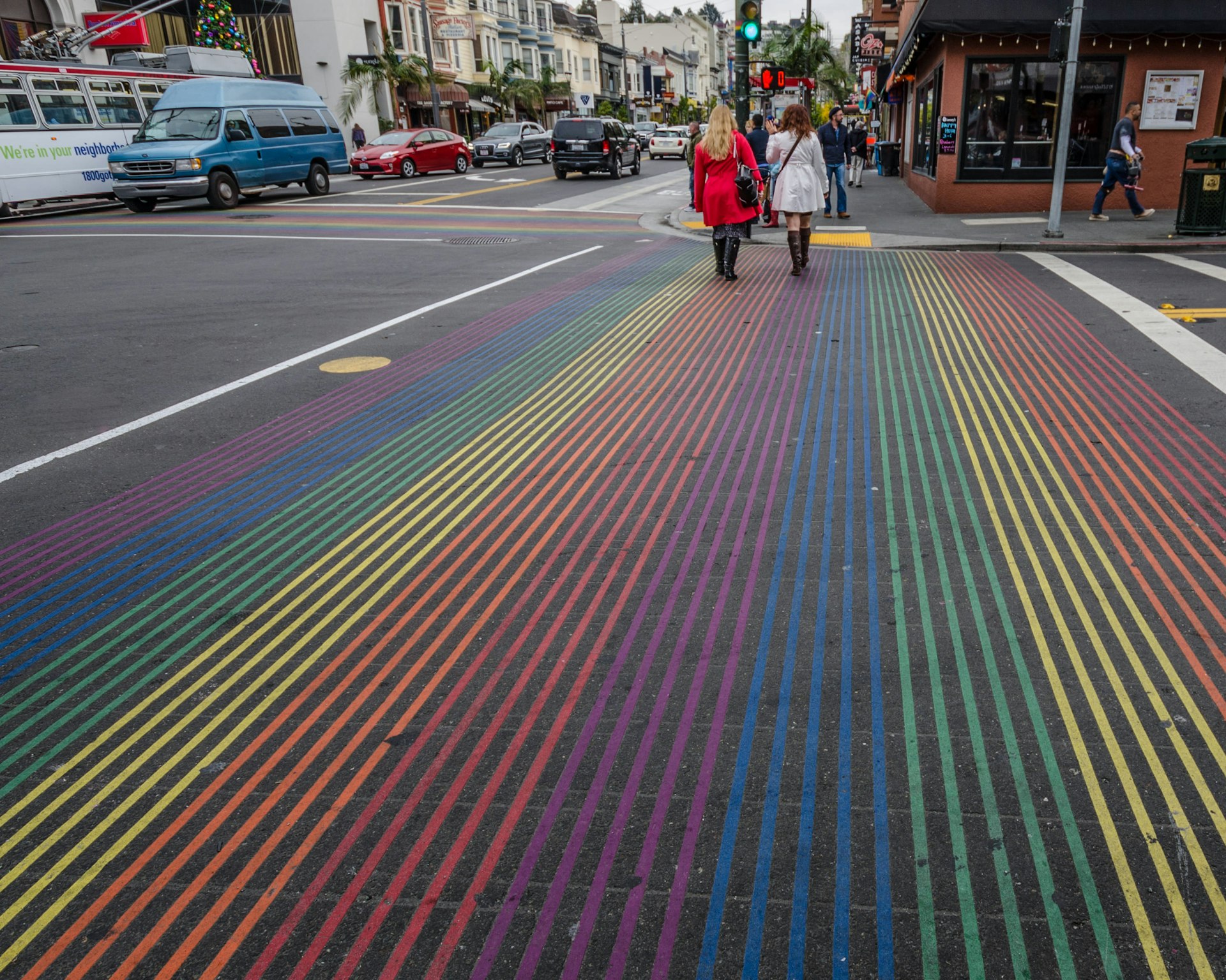 Two women cross Castro Street with its rainbow colors at 18th Street in the heart of the gay village and one of the city's most vibrant communities.