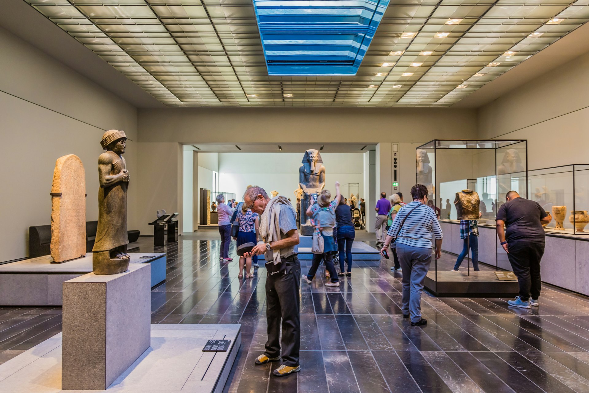 Visitors looking at exhibits in the 2nd Gallery of the Louvre Abu Dhabi, dedicated to The First Great Powers.