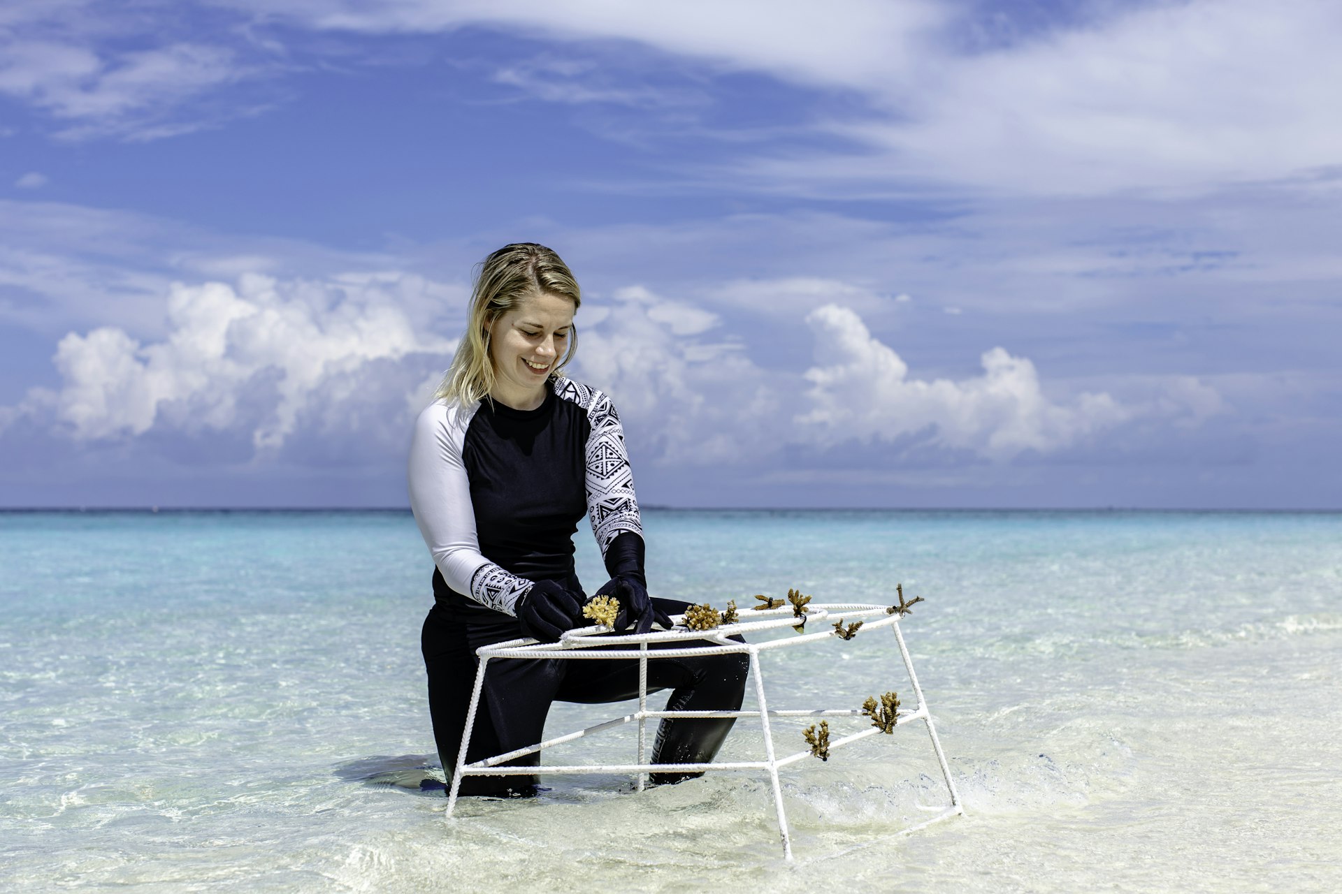 A woman tends to coral fragments, the Maldives