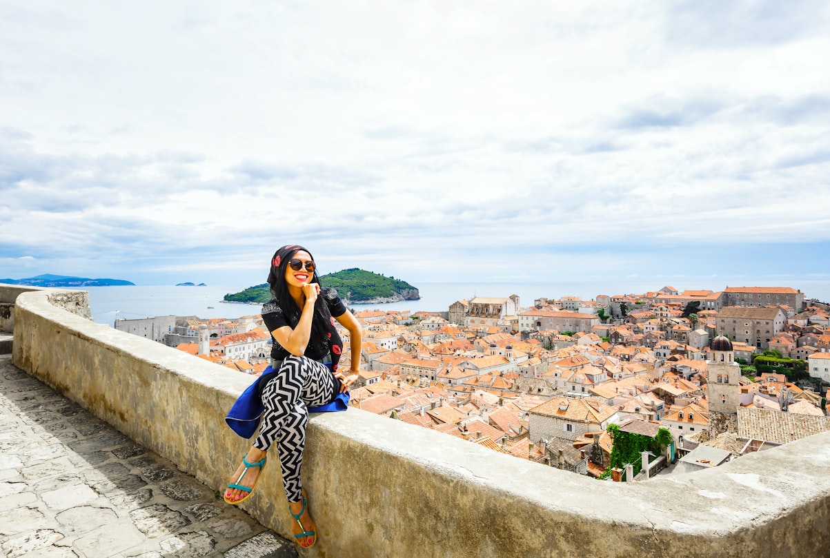 Happy smiling female tourist at Dubrovnik old city wall and old town by Adriatic sea of Croatia; Shutterstock ID 466118216; your: Claire Naylor; gl: 65050; netsuite: Online Ed; full: Dubrovnik neighborhoods
466118216
adriatic, asian, attractive, beautiful, city, croatia, dalmatia, destination, dubrovnik, europe, famous, fashioned, female, hair, heritage, history, lifestyle, mediterranean, old, orange, outdoor, photo, photography, place, pretty, roof, sea, spring, summer, taking, tourism, tourist, travel, vacation, walls, woman, world, young
