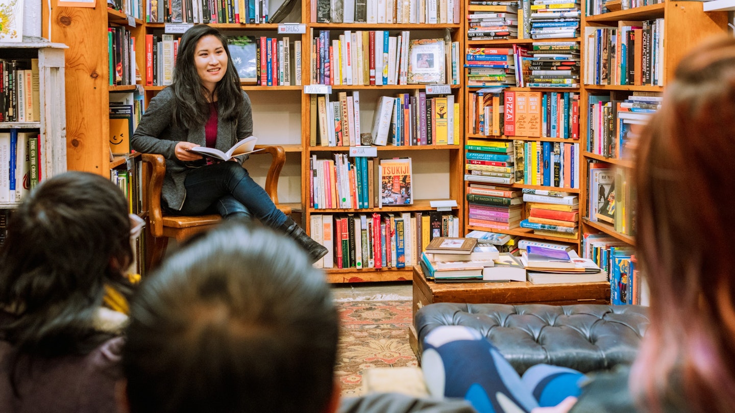A woman reading to a small audience in an independent bookstore in San Francisco.
Getty, RFE, Adult, Book, Bookcase, Boy, Child, Clothing, Female, Footwear, Furniture, Indoors, Library, Male, Person, Publication, Shelf, Shoe, Shop, Woman
