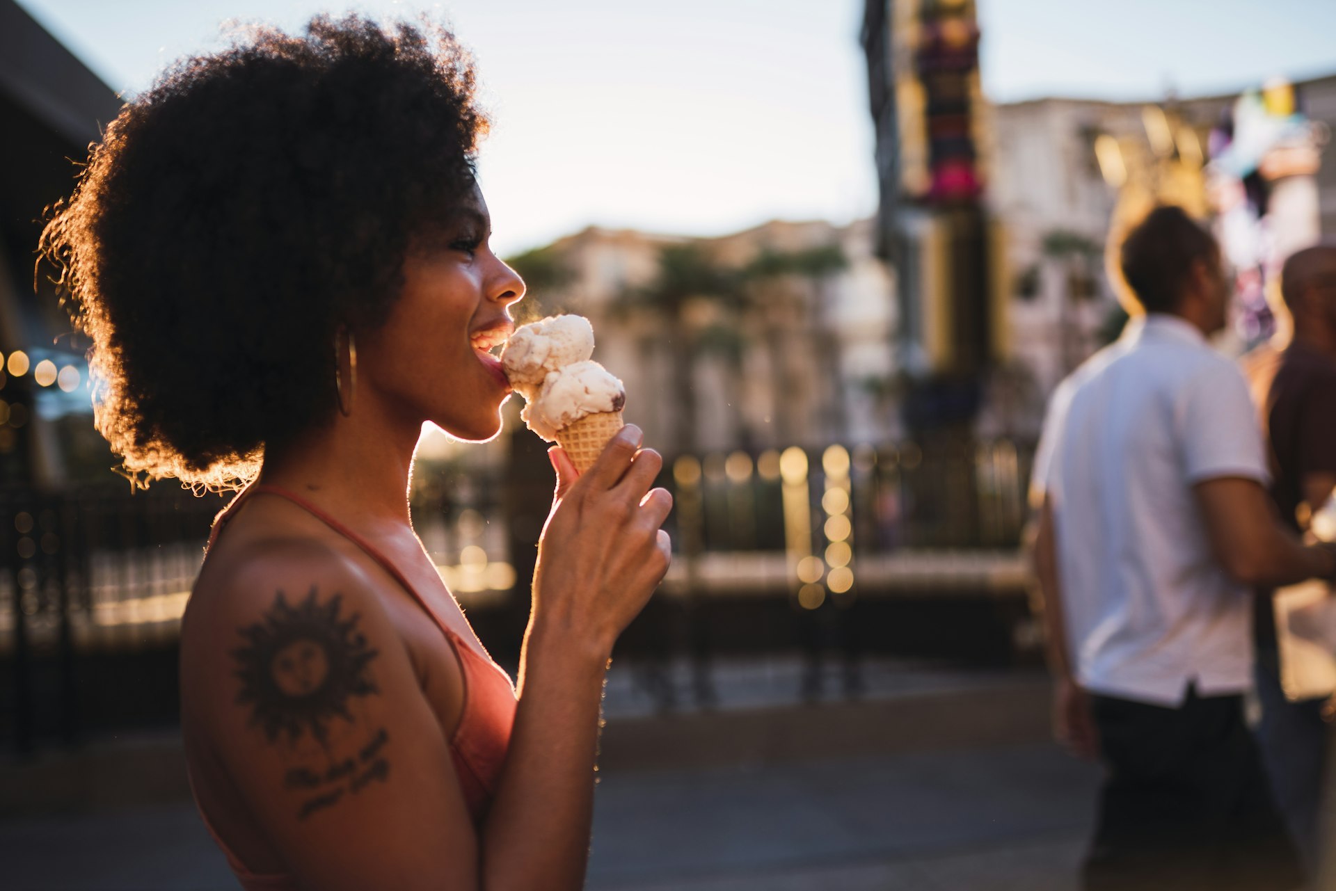 A woman eats ice cream while walking down a Vegas Street
