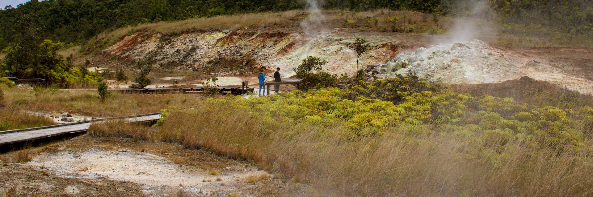 Tourists view the Sulphur banks that can be found walking along the boardwalk in Volcanoes National Park on the Big Island, Hawaii. Volcanic gases steam from the ground as sulphur vents / steam vents
1285860174
steam vents, sulphur vents, volcanoes national park, sulphur dioxide, attraction, tourists, trail, crater rim trail, soil acidity, pathways, cracks, magma, sulfur, rotten egg, hydrogen sulfide, h2s, so2, ground water, emitted, ha'akulamanu, vaporizes, steaming bluff, wahinekapu, tourist attraction, volcanic gases, sulphur vent, sulfur vent, sulphur bank, steam banks, big island, hawaii