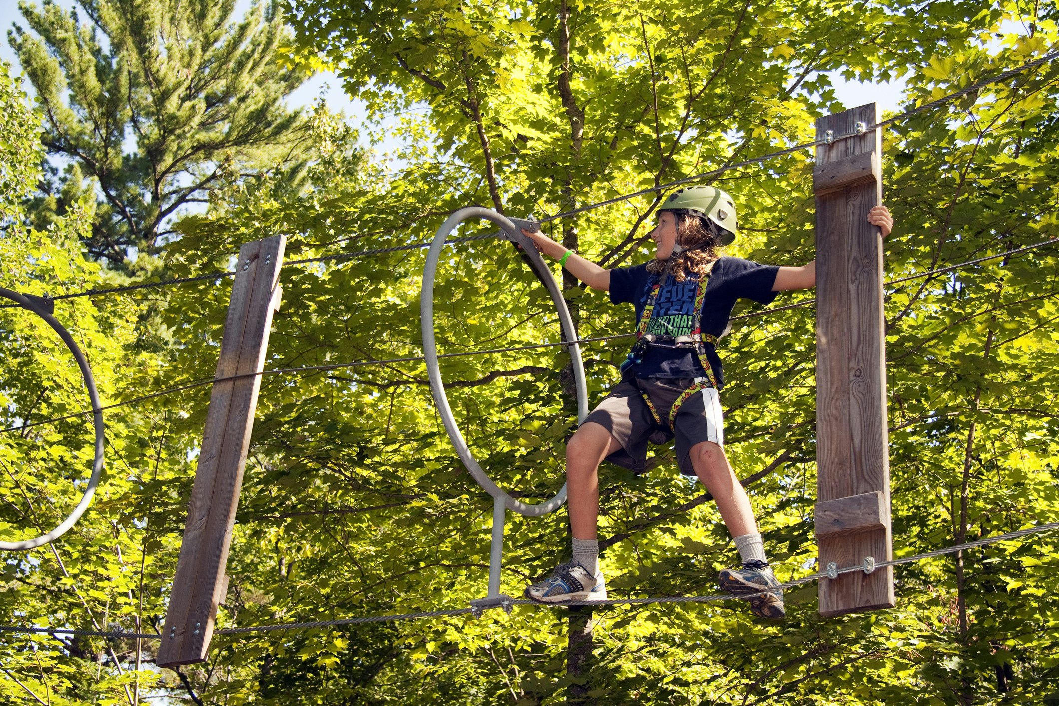 A boy navigating an aerial rope course