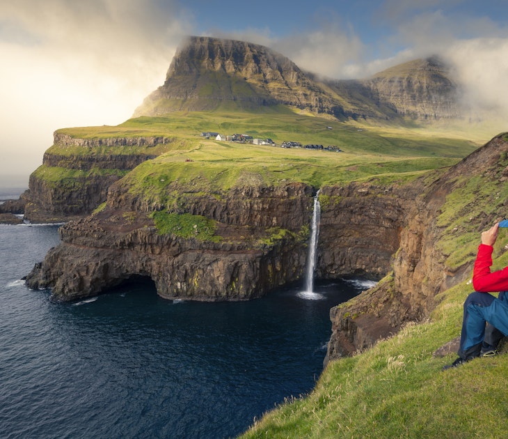 Man with red jacket sits at cliff in front of MÃºlafossur waterfall with GÃ¡sadalur village on Vagar island, Faroe Islands"n
Man with red jacket sits at cliff in front of Múlafossur waterfall with Gásadalur village on Vagar island, Faroe Islands"n
1329702595
faeroe islands, spcc, múlafossur, gásadalur, cliffs, rocks, ocean, coast, man, male, person, clouds, vagar, landscape, scenery, travel destination