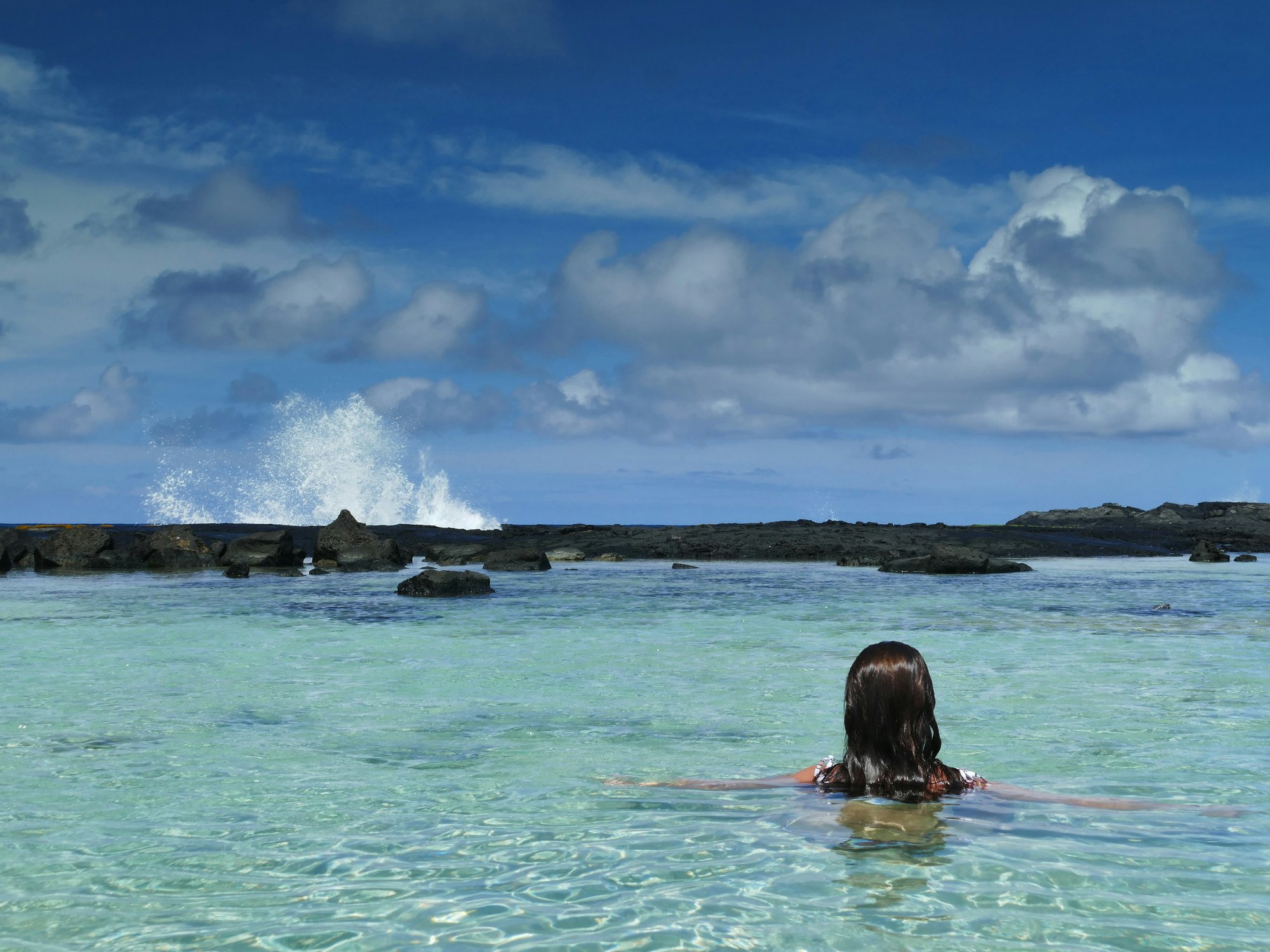 1343022158
Wawaloli Beach Park, Kalaoa, Kailua-Kona, Hawaiâ€™i - September 18, 2019:  Woman enjoys the protected waters of the tide pools at Wawaloli Beach while the surf crashes in the distance.
Wawaloli Beach Park, Kalaoa, Kailua-Kona, Hawai’i - September 18, 2019:  Woman enjoys the protected waters of the tide pools at Wawaloli Beach while the surf crashes in the distance.
