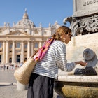 Woman drinks water from fountain on the main square in Vatican. Concept of visiting the Vatican
1390980484