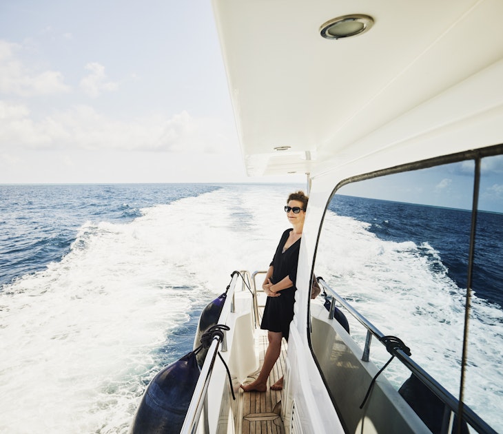 Wide shot of mature woman enjoying view while cruising on yacht in Indian Ocean in the Maldives
1392627671