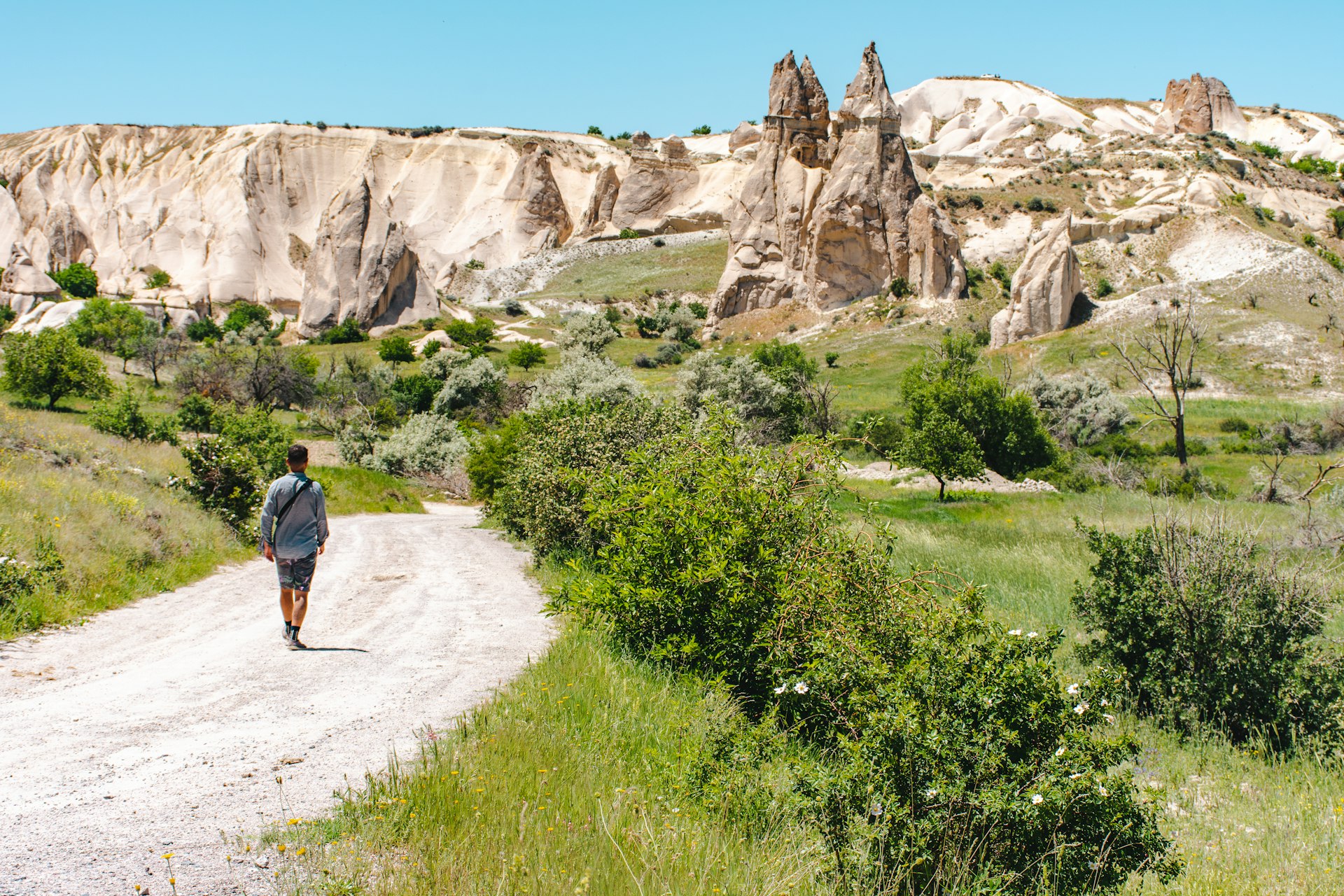 Rear view of man walking in a gravel road towards love valley in Goreme, Cappadocia