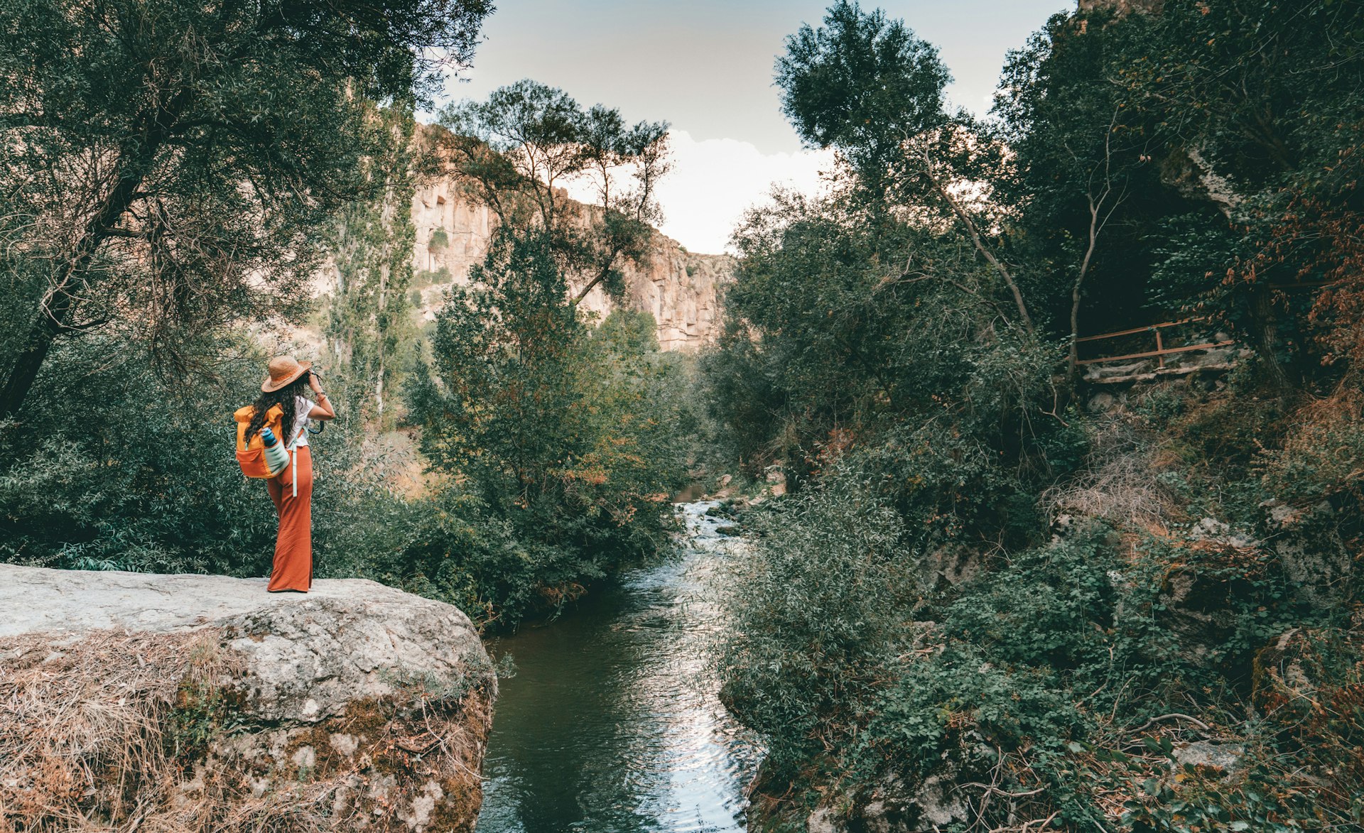 A woman standing next to a river in Ihlara Valley, Turkey