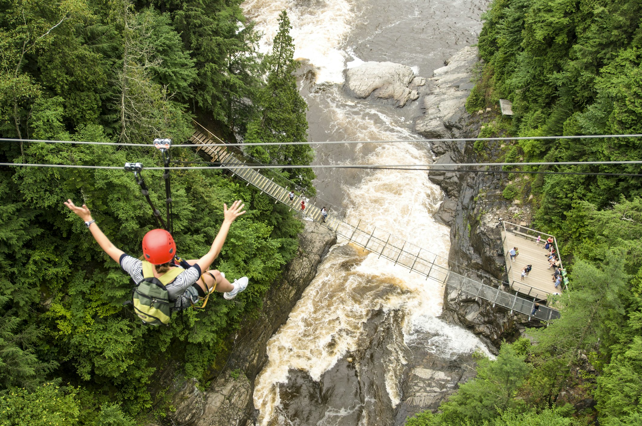 A woman ziplining at Montmorency Falls, Québec City