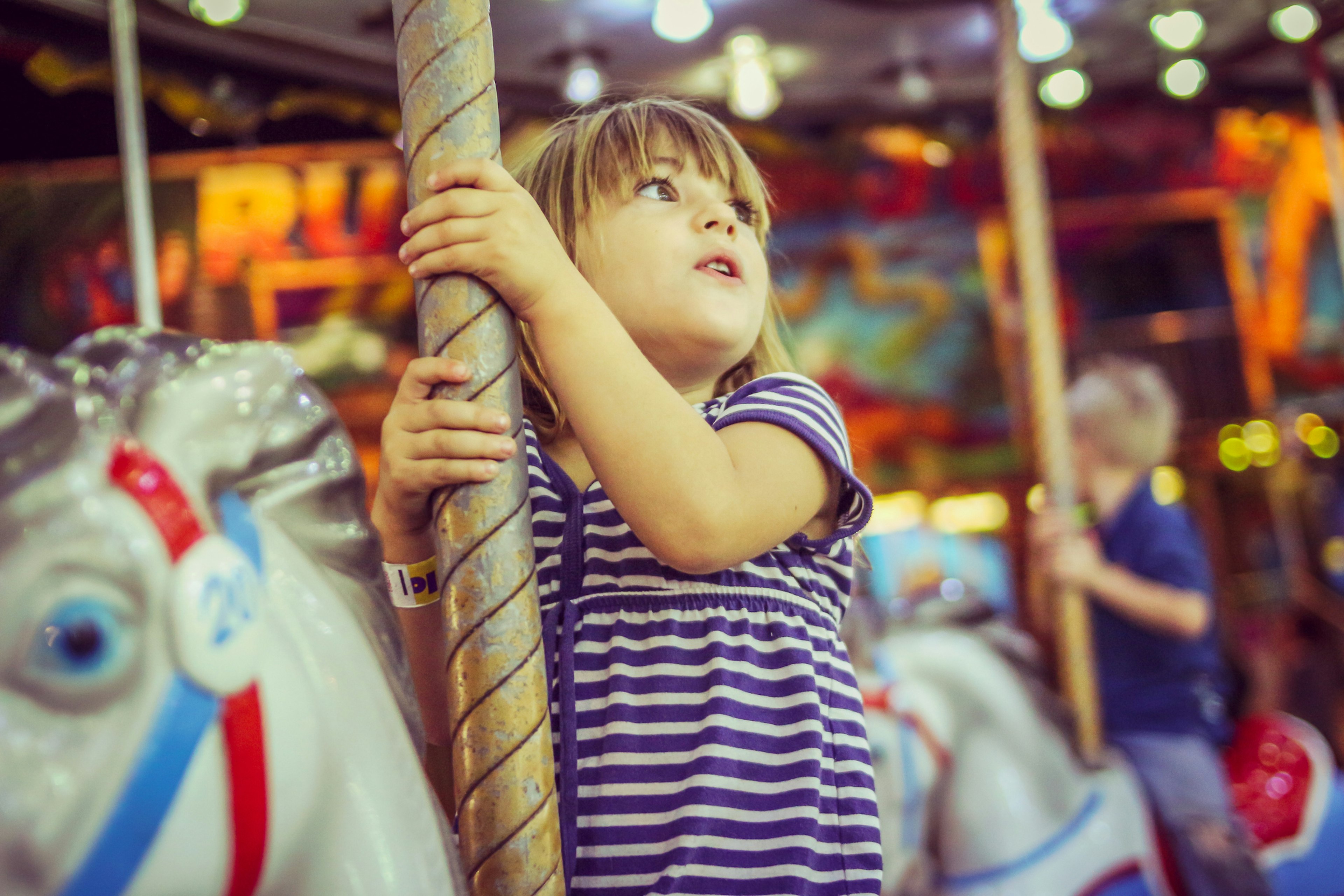 Little girl on a carousel horse