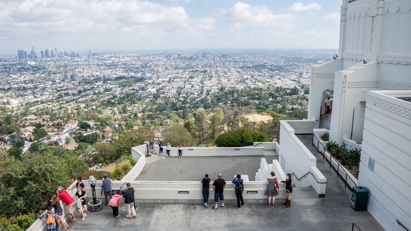 Los Angeles, California, USA - June 12, 2017: picturesque panorama of Griffith Park in Los Angeles, an area and a lawn in front of the Griffith Observatory, Hollywood Hills, Los Angeles. The famous tourist and science attraction of Los Angeles. A popular place for picnics and walks.
892991666