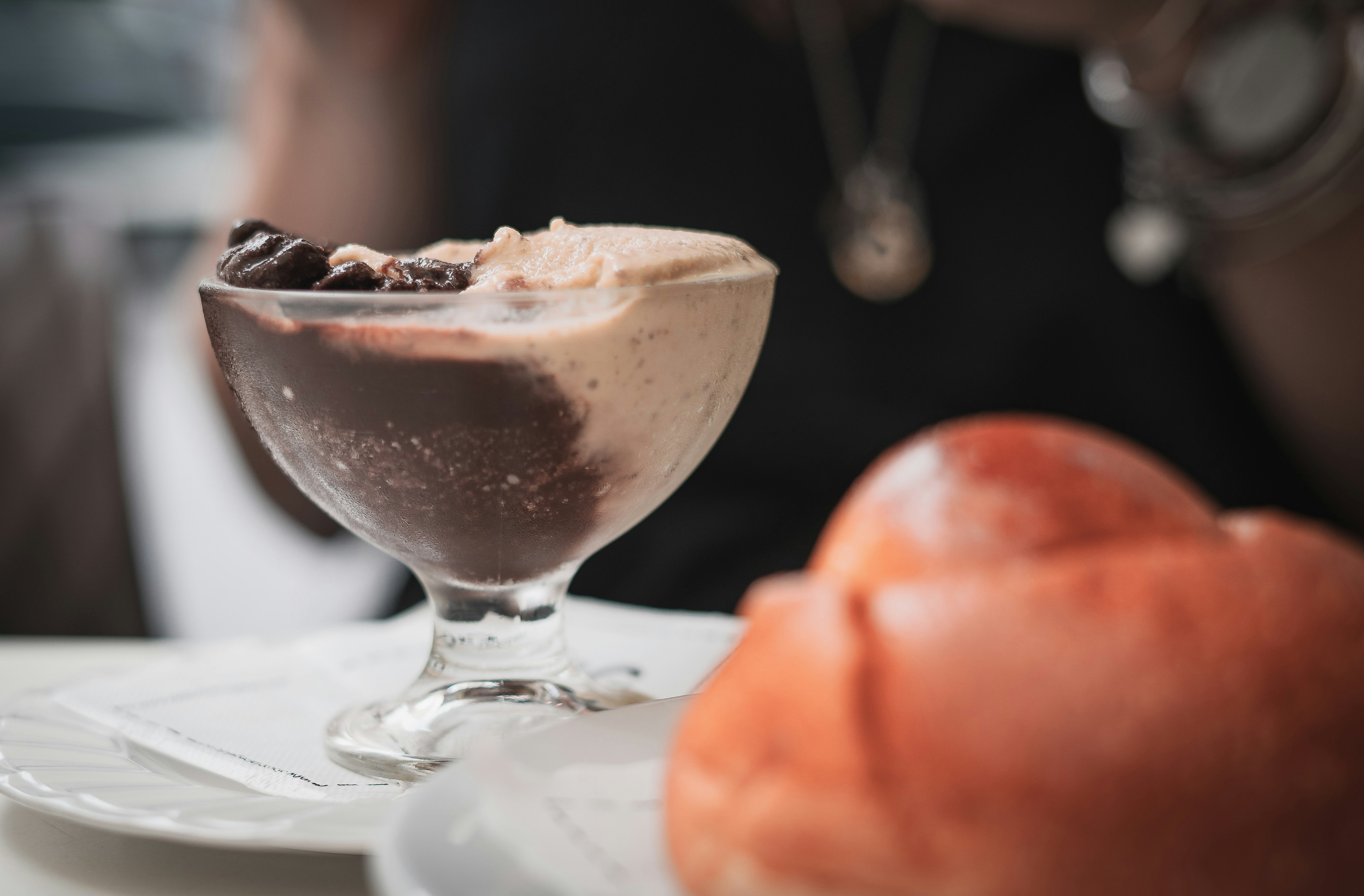 A close up of Sicilian granita ice creatm with a brioche bun blurred in front