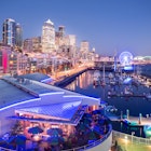 Elevated view of Seattle skyline and restaurants in Bell Harbour Marina at dusk, Belltown District, Seattle, Washington State, United States of Americ