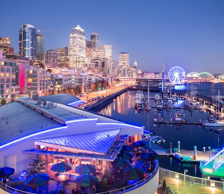 Elevated view of Seattle skyline and restaurants in Bell Harbour Marina at dusk, Belltown District, Seattle, Washington State, United States of Americ