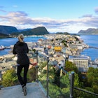 Blond woman enjoying aerial view of the colorful art nouveau town of Alesund Norway
1195943087