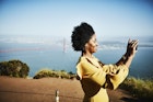 A black woman smiling and taking a picture of San Francisco with the Golden Gate Bridge in the background
820965032
San Francisco, Golden Gate Bridge, black woman, solo woman traveler, smiling, sunshine