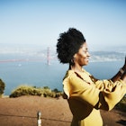 A black woman smiling and taking a picture of San Francisco with the Golden Gate Bridge in the background
820965032
San Francisco, Golden Gate Bridge, black woman, solo woman traveler, smiling, sunshine