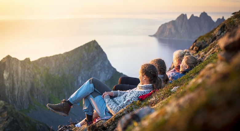 Friends relaxing together at sunset lying down on mountain ridge, Senja island, Troms county, Norway
1356638629