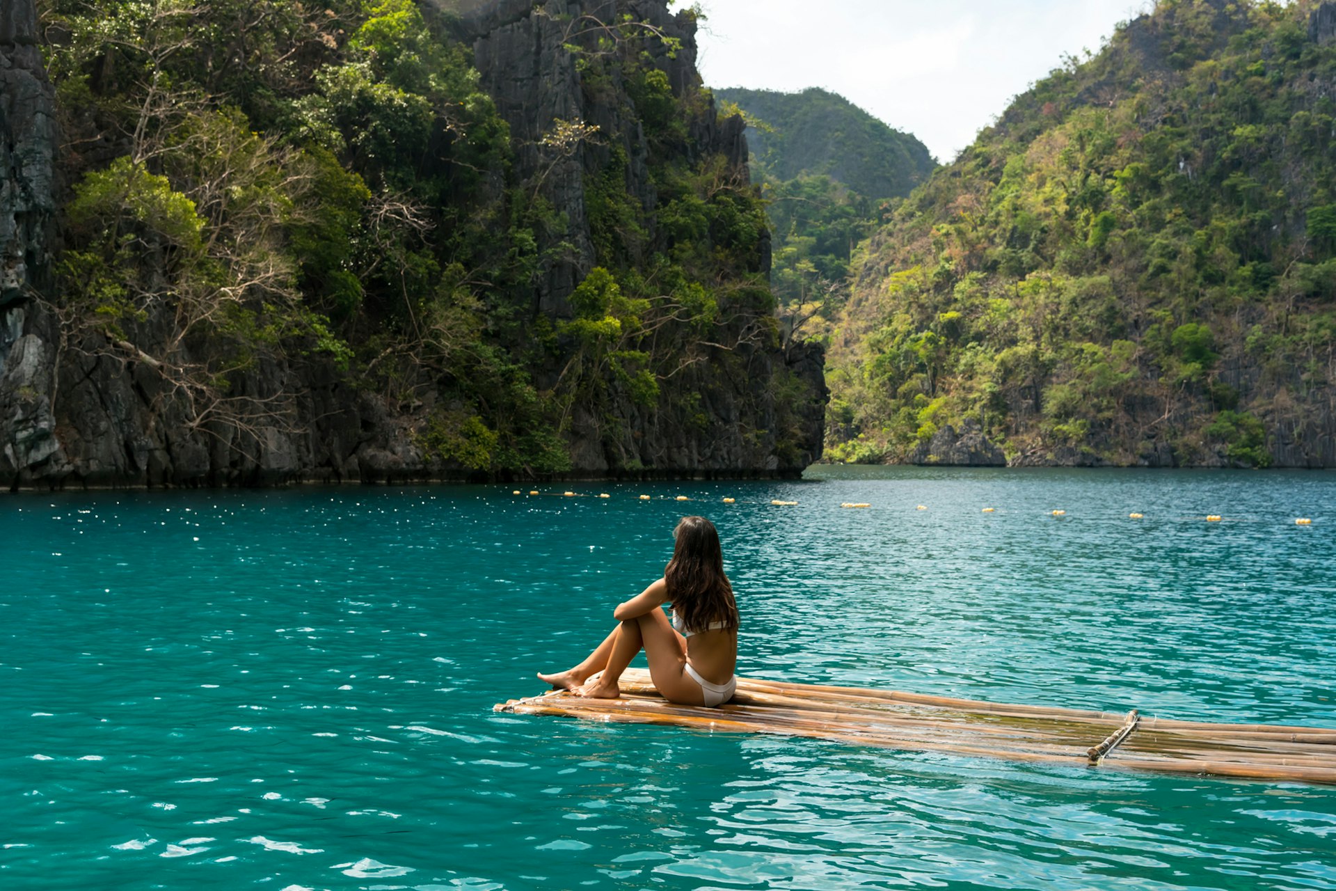 A woman sits by the water in Coron, Palawan, the Philippines