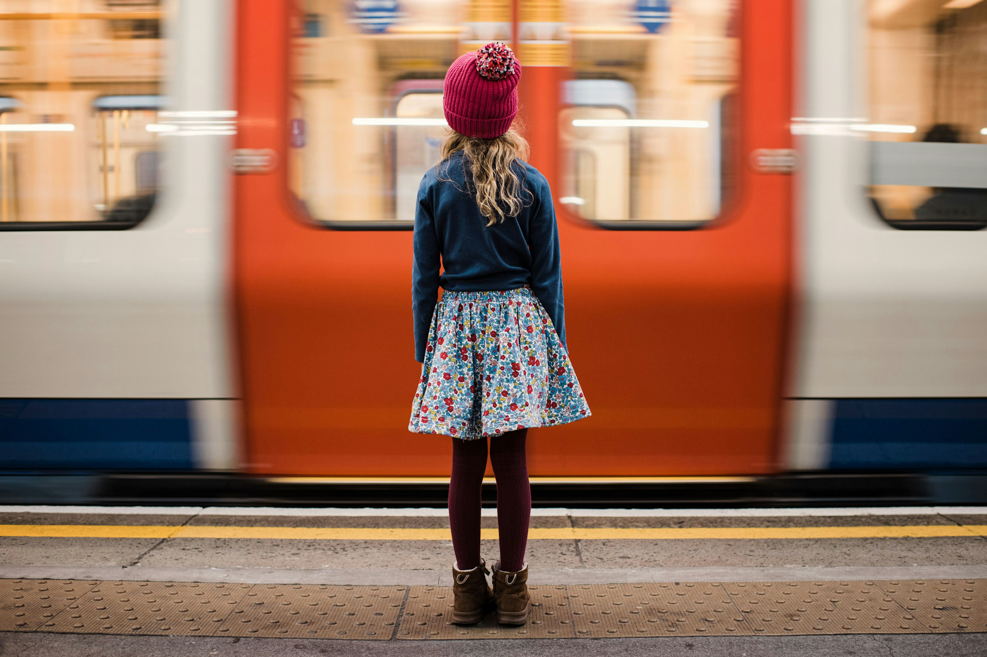 A girl stood waiting for a Tube on the platform in London