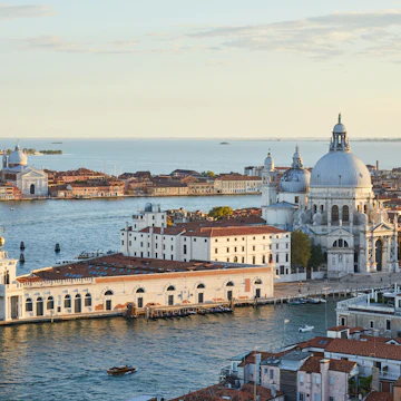 Saint Mary of Health basilica in Venice and Punta della Dogana, aerial view at sunset in Italy