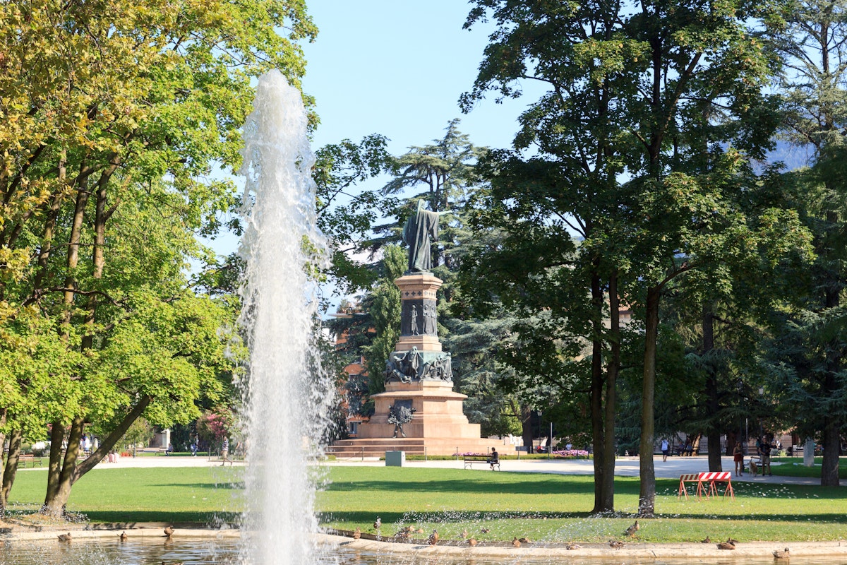 Fountain and monument statue of Dante Alighieri in park Giardini Pubblici in Trento, Italy