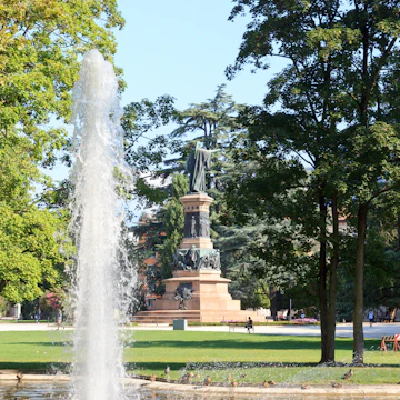 Fountain and monument statue of Dante Alighieri in park Giardini Pubblici in Trento, Italy
