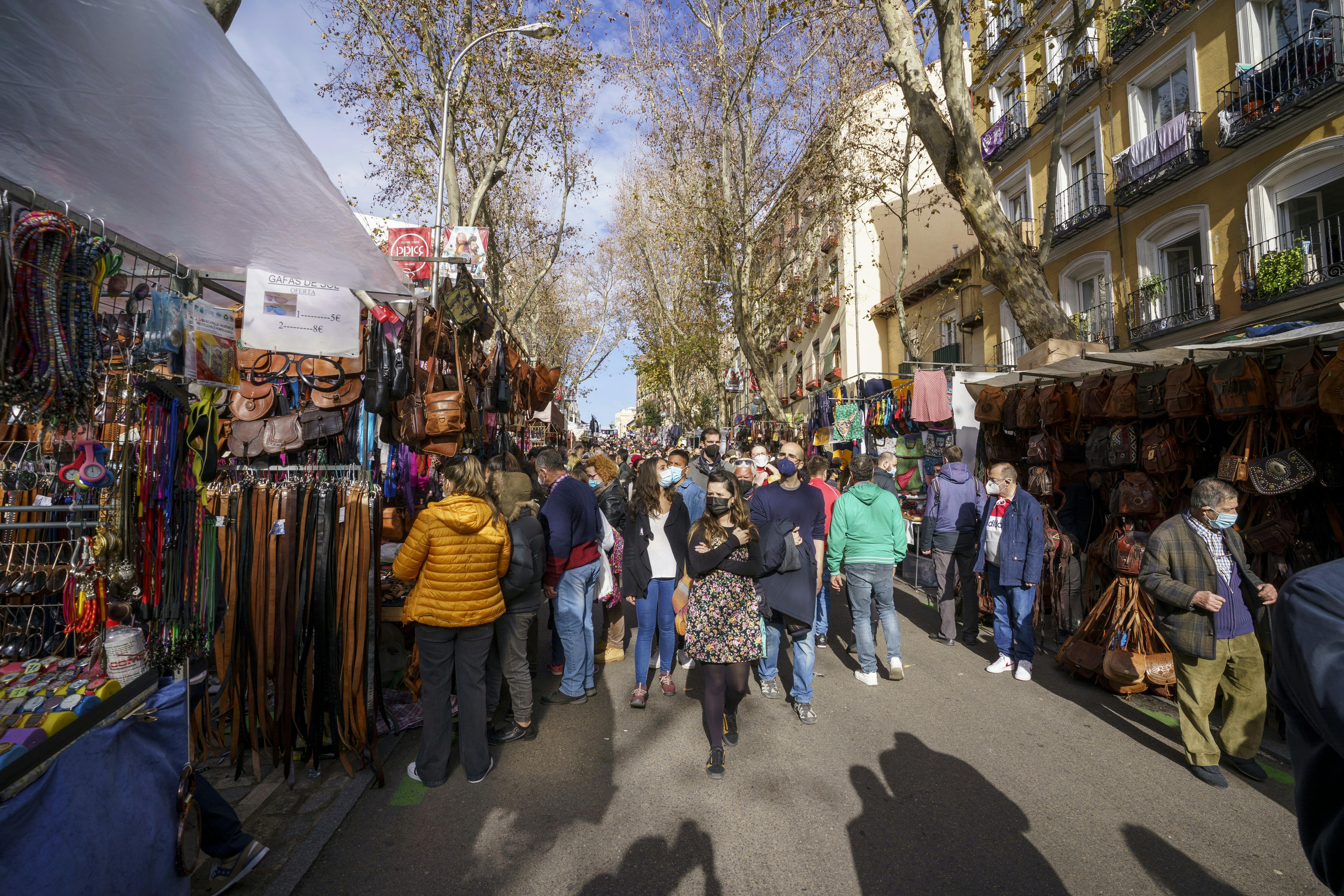 Traditional market in Madrid during a sunny day with many people shopping, Rastro de Madrid