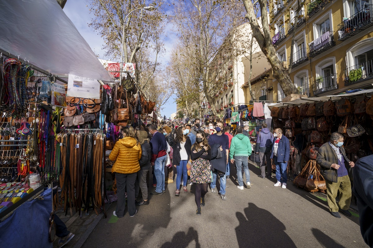 Traditional market in Madrid during a sunny day with many people shopping, Rastro de Madrid