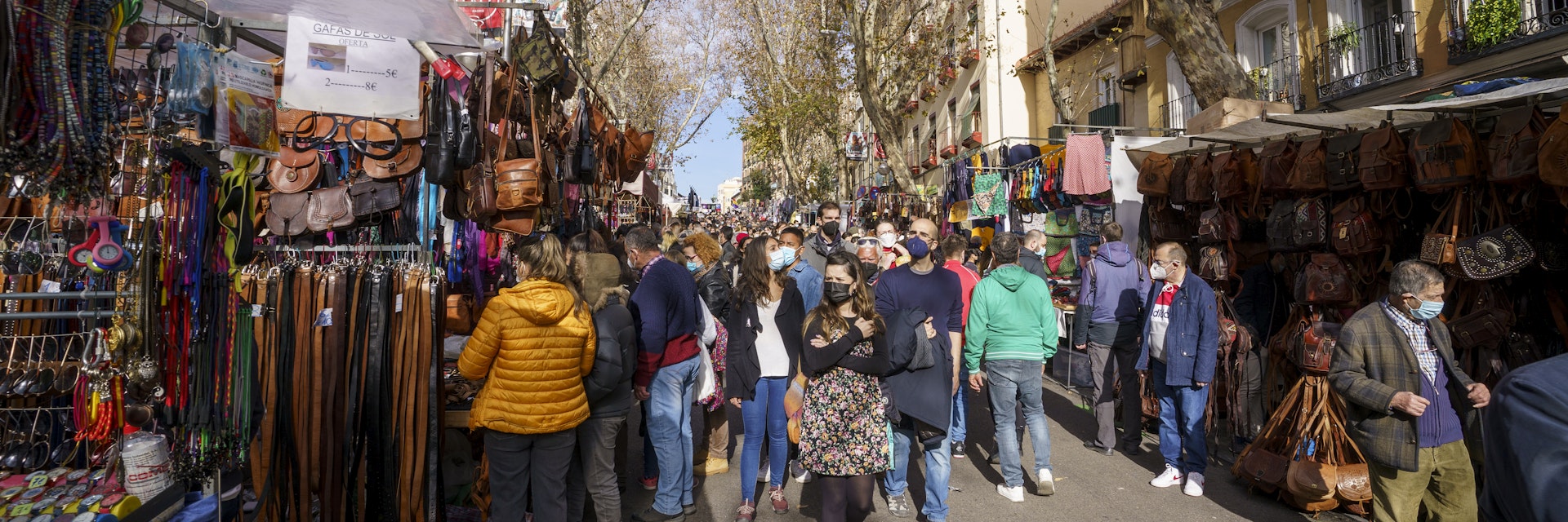 Traditional market in Madrid during a sunny day with many people shopping, Rastro de Madrid