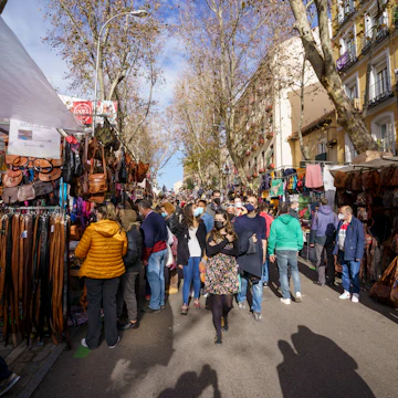 Traditional market in Madrid during a sunny day with many people shopping, Rastro de Madrid