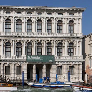 The white marble facade of Ca' Rezzonico on the Grand Canal in Venice. Italy