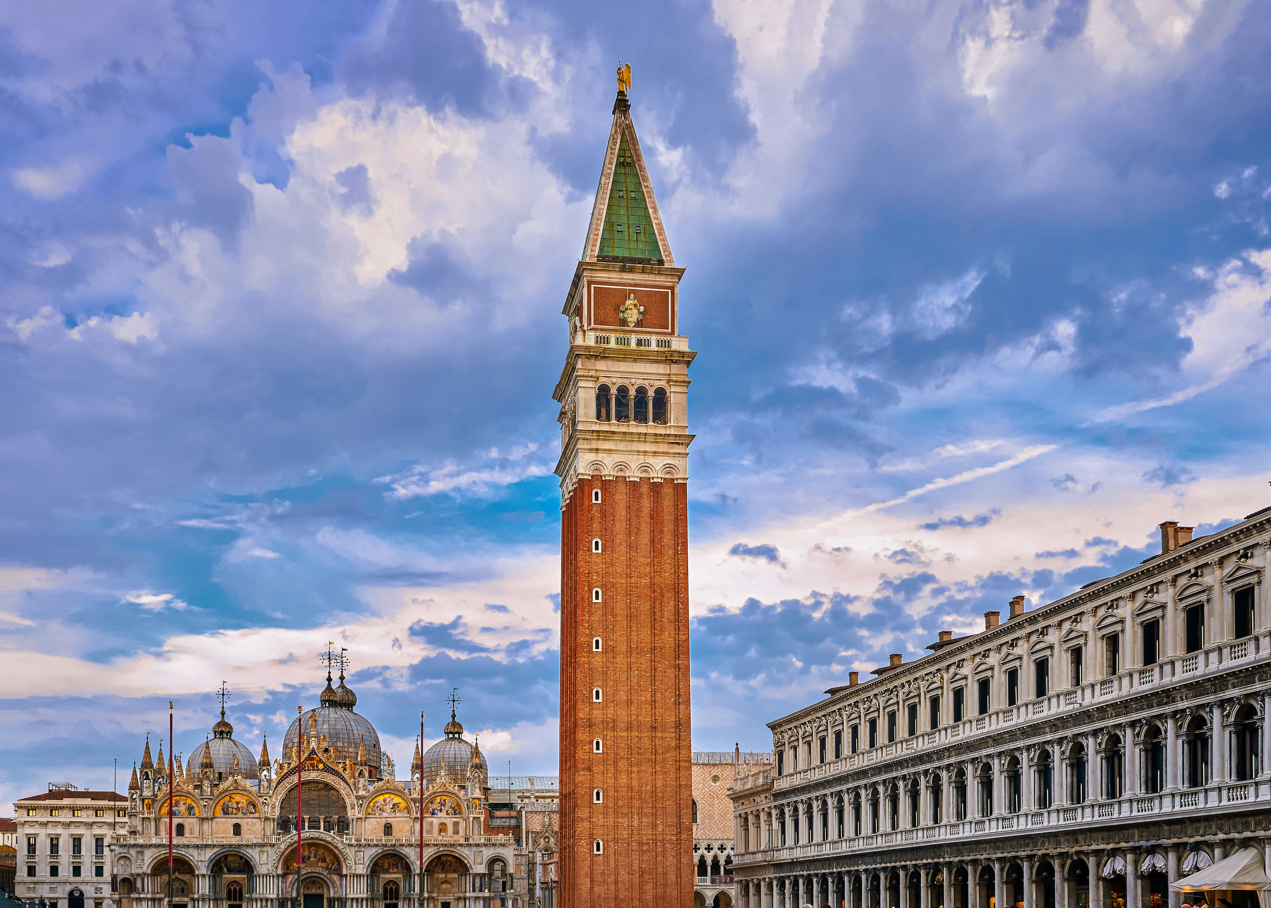 View of St Mark's square or piazza di San Marco, Venice, Italy, sundown on cloudy day. Bell tower or Campanile, St Mark's Basilica main facade and entrance and Procurate Vecchie building, beautiful sky and clouds, UNESCO World heritage city.
1584875726
View of St Mark's square or piazza di San Marco, Venice, Italy in sundown on cloudy day. Campanile, St Mark's Basilica, Procurate Vecchie building