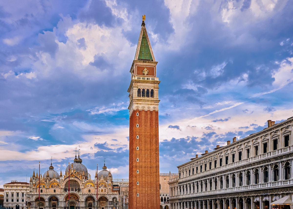 View of St Mark's square or piazza di San Marco, Venice, Italy, sundown on cloudy day. Bell tower or Campanile, St Mark's Basilica main facade and entrance and Procurate Vecchie building, beautiful sky and clouds, UNESCO World heritage city.
1584875726
View of St Mark's square or piazza di San Marco, Venice, Italy in sundown on cloudy day. Campanile, St Mark's Basilica, Procurate Vecchie building